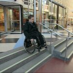 Go down a flight of stairs without handrail in a wheelchair